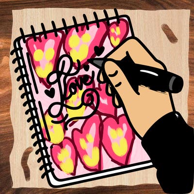 a hand writing “love” in calligraphy on a notebook