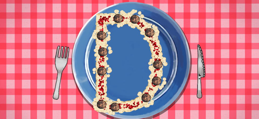 La lettera D formata con polpette e purè di patate su un piatto blu da cena