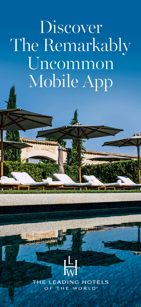 ラウンジチェアと傘のある高級リゾートのプールの写真。ザ・リーディング・ホテル・オブ・ザ・ワールドのアプリを宣伝。