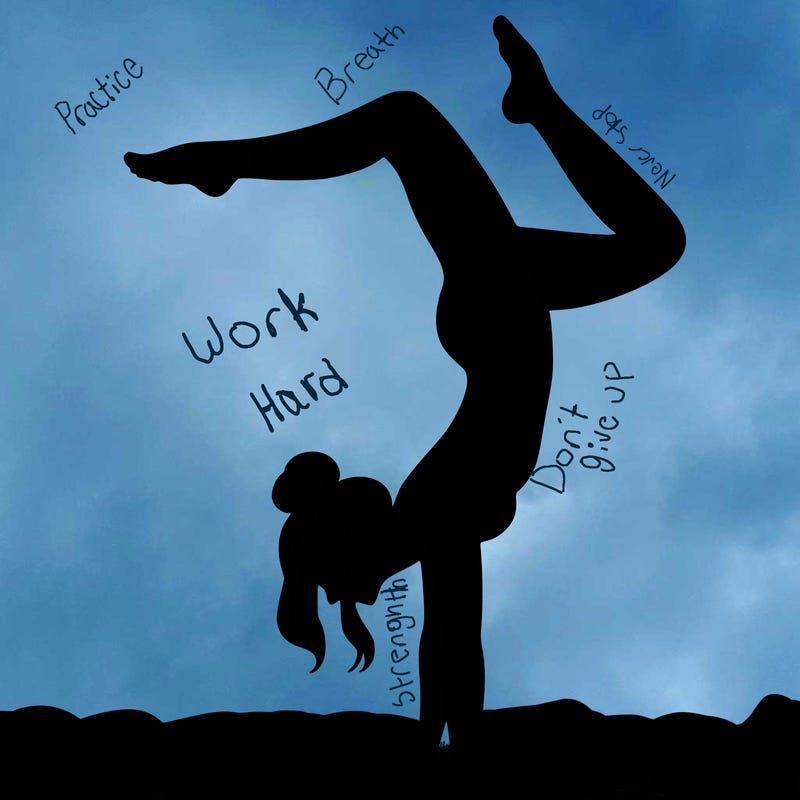 a woman doing a handstand