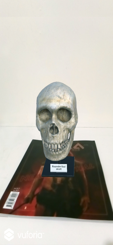 OYLA Science AR - A 3D augmented reality model of a Neanderthal skull hovering over an OYLA Science magazine.