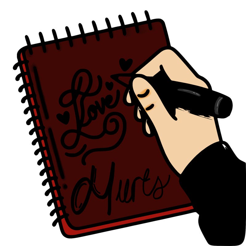 a hand writing “love” in calligraphy on a notebook