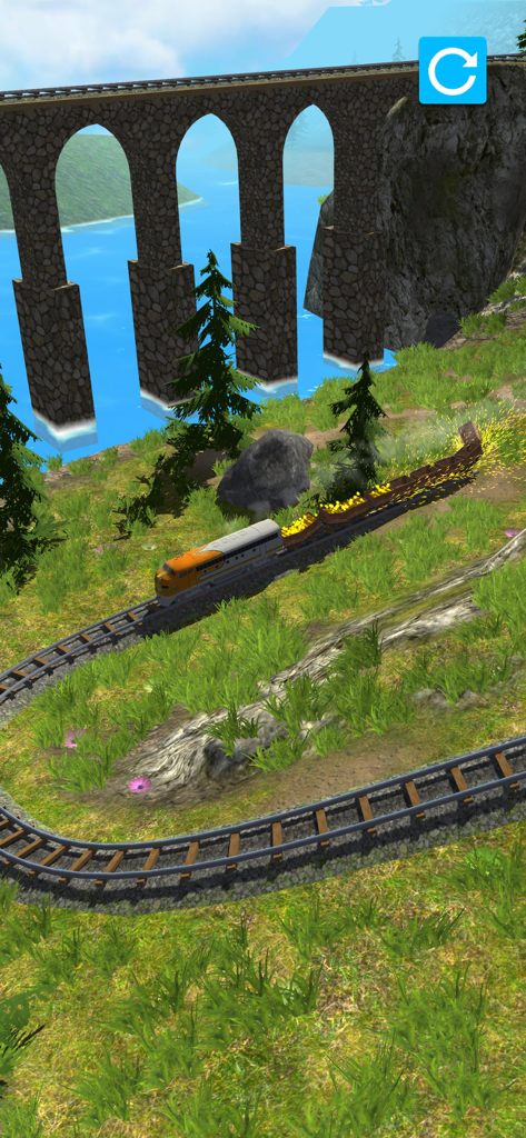 A train on a curved track with a large stone arch bridge and lake in the background