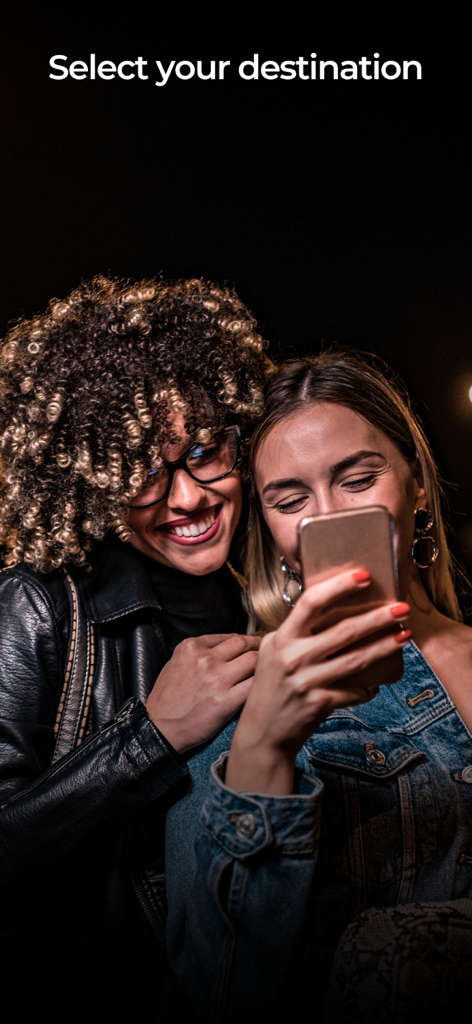 BlackWolf App - Two women smiling while using the BlackWolf app to book a ride at night