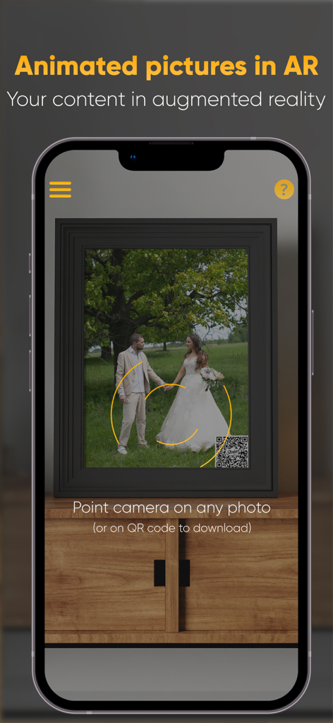 Stories AR - Smartphone scanning a framed wedding photo to activate augmented reality animation.