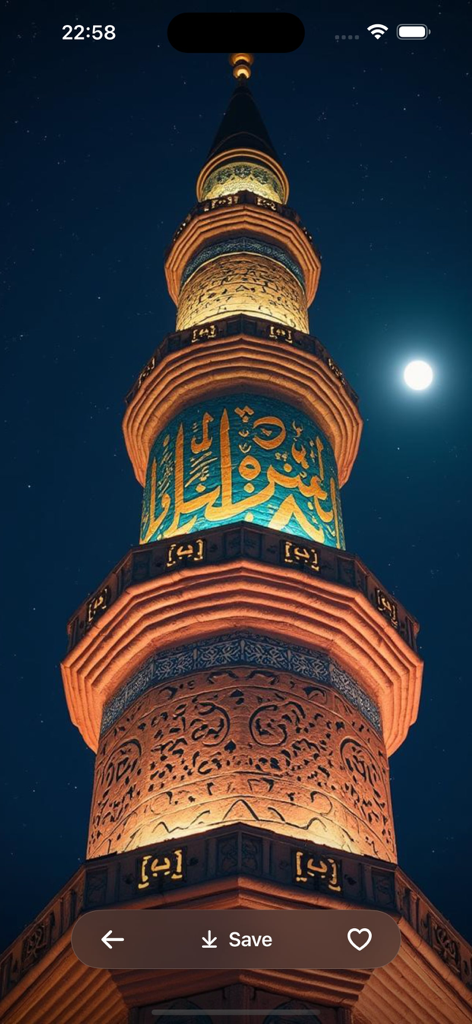A tall illuminated mosque minaret with Arabic calligraphy at night under a full moon