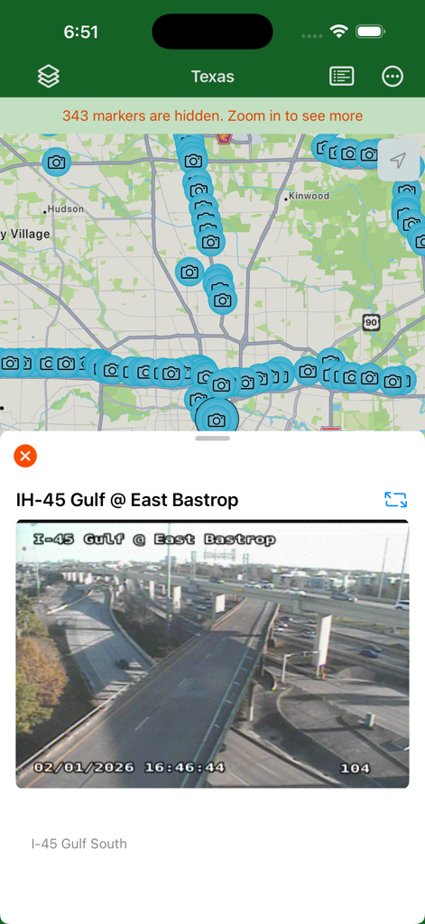 Texas Traveler - A real time traffic camera view for IH 45 Gulf at East Bastrop displayed over a map with numerous camera icons in the Texas Traveler navigation app.
