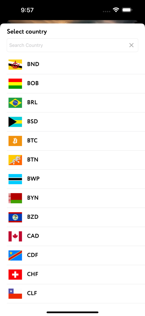 A minimalist mobile app screen for selecting a country and currency from a list featuring flags and ISO codes like BTC BRL and CAD