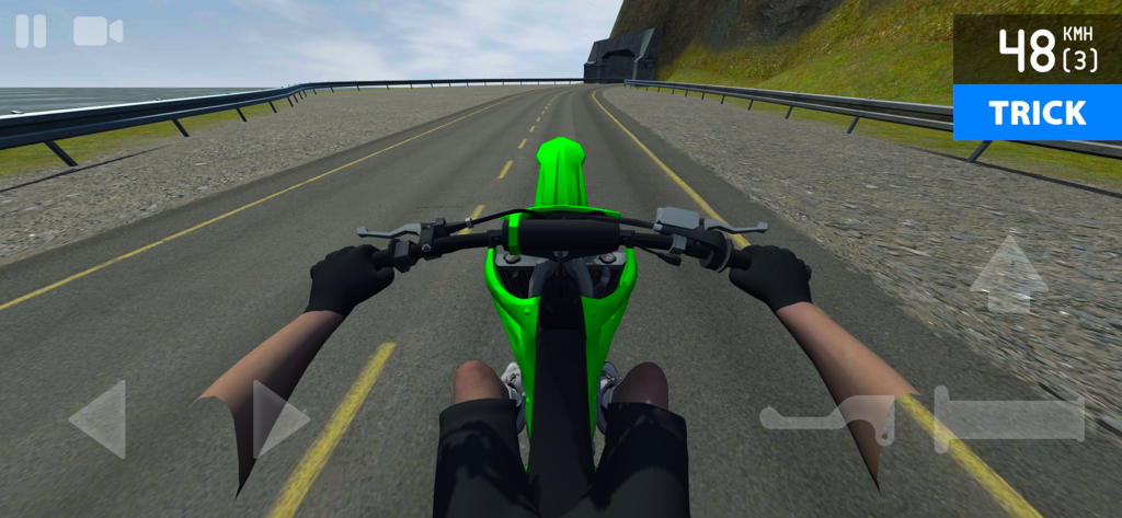 First person view of a green motorcycle performing a wheelie trick on an open road