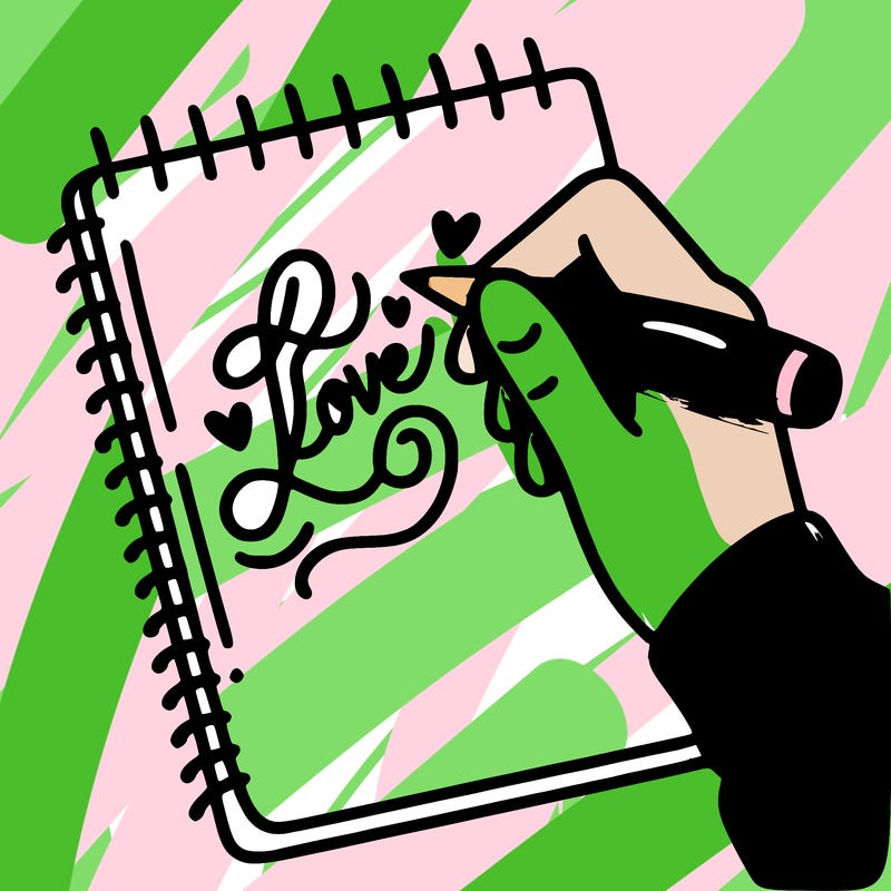a hand writing “love” in calligraphy on a notebook