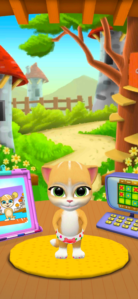 My Talking Cat Emma - La gata virtual Emma de pie en su colorido cuarto de juegos con un caballete para colorear y una tableta de juegos.