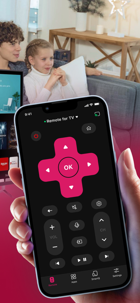 A hand holding an iPhone displaying a smart TV remote app with a family sitting on a couch in the background