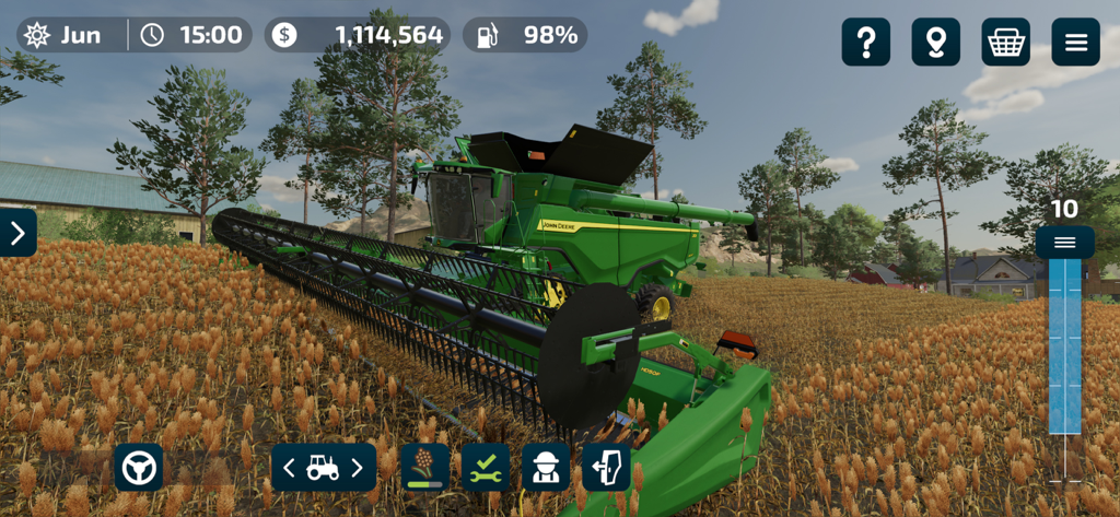 John Deere combine harvester harvesting crops in Farming Simulator 23 Mobile