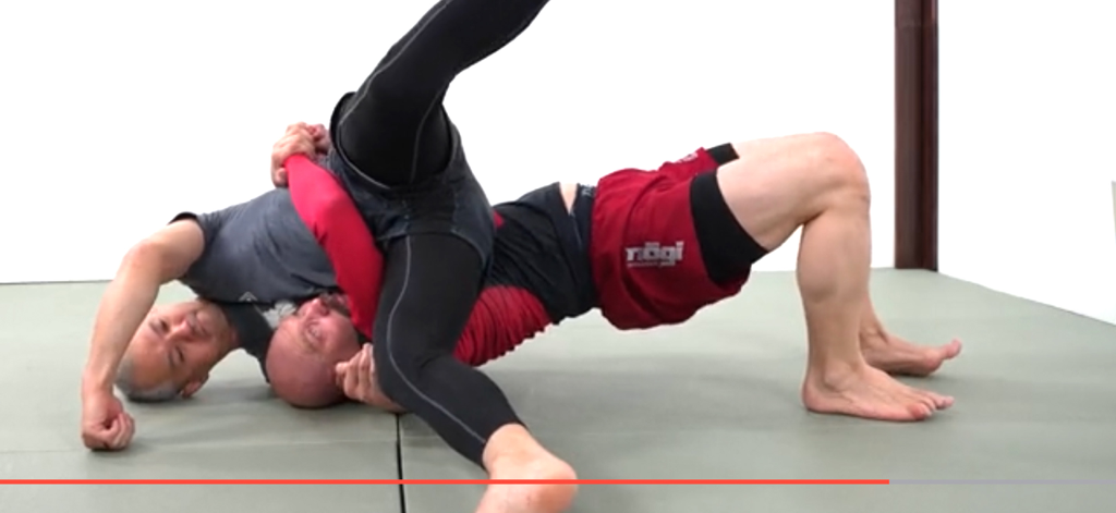 BJJ Master App by Grapplearts - Two men demonstrating a BJJ grappling technique on a mat in a video instructional