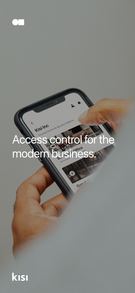 Kisi - A professional hand holding a smartphone displaying the Kisi access control interface for modern businesses.