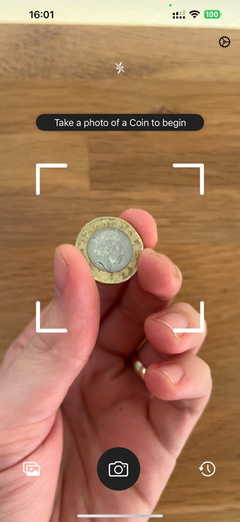 Coin Scanner: Identify & Value - Hand holding a coin within the Coin Scanner app camera view for identification