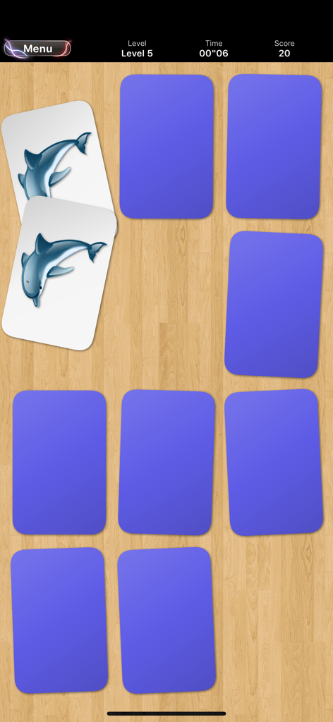 Memory • Platinium - A memory matching game screen showing two flipped cards with dolphin illustrations on a wooden background