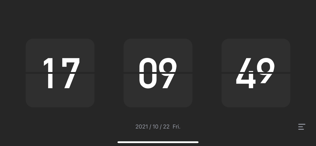 A minimalist digital flip clock in dark mode displaying hours minutes and seconds with a date at the bottom