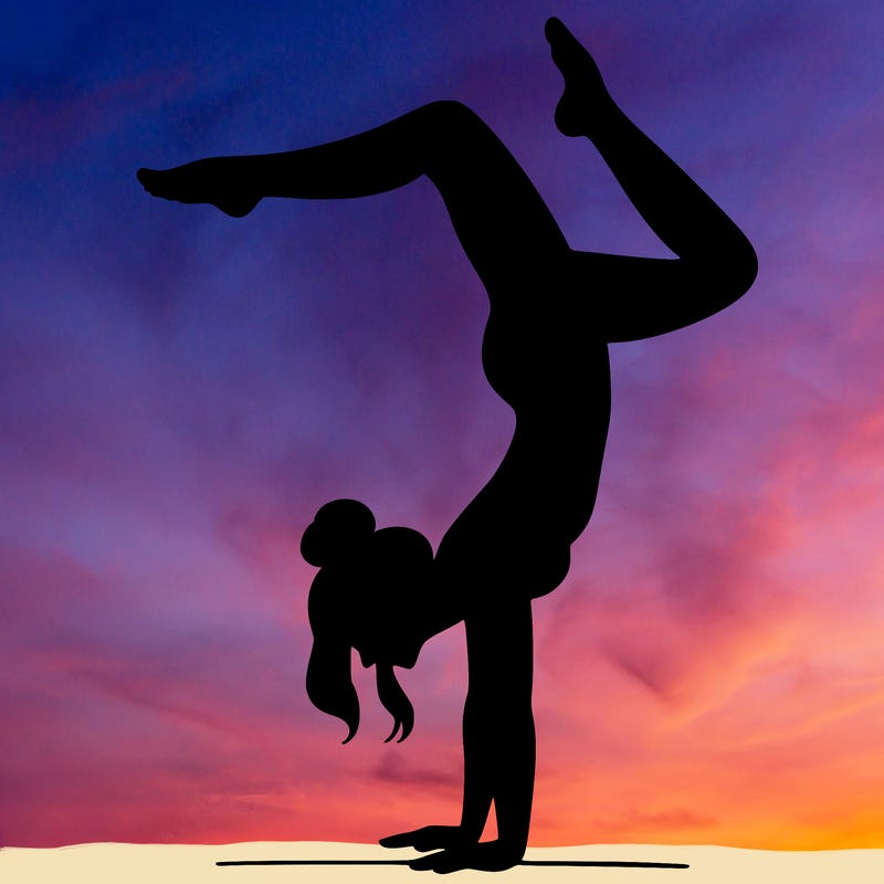 a woman doing a handstand