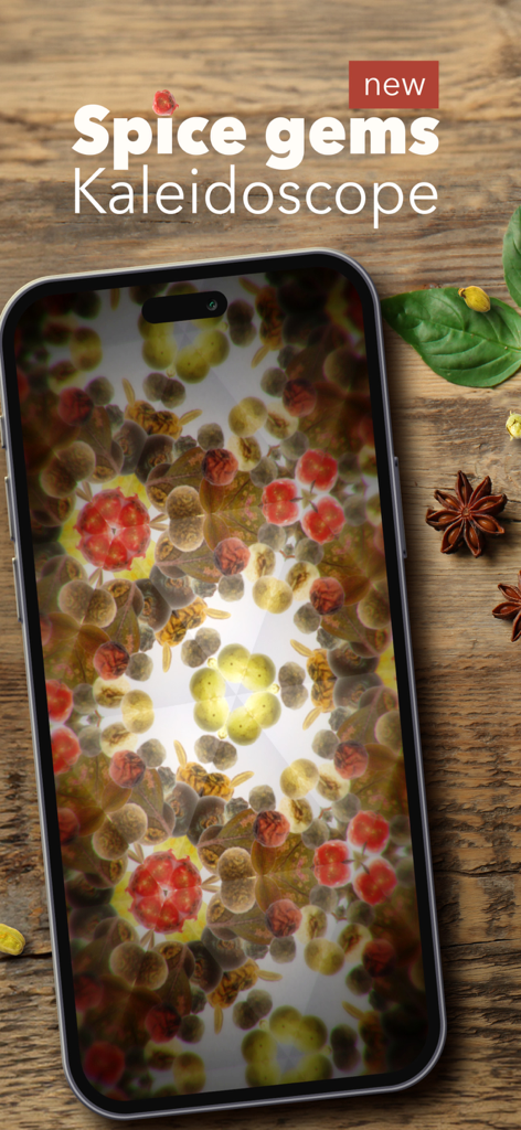 Real Kaleidoscope PRO - A smartphone on a wooden surface displaying a spice gems kaleidoscope pattern within the Real Kaleidoscope PRO app.