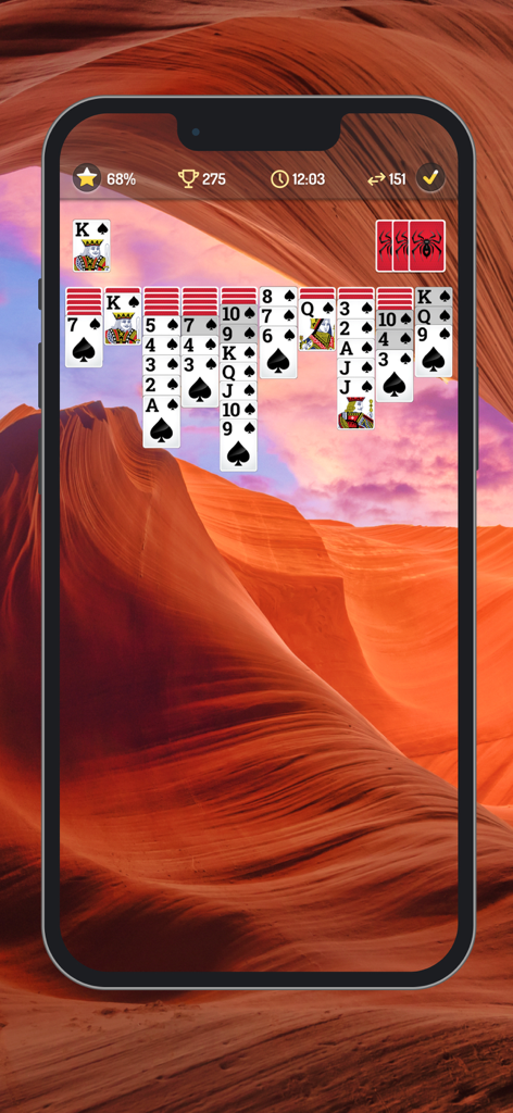 Interfaz de juego de Spider Solitaire con un fondo de cañón desértico y fuentes de cartas grandes.