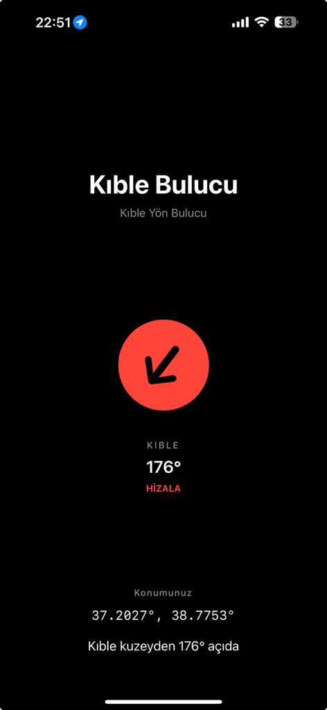 A minimalist dark mode interface of the Ad-Free Qibla Finder app displaying a red compass arrow pointing towards the Qibla direction with coordinates.