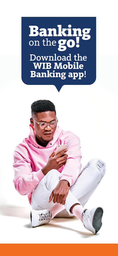 A man sitting and using the WIB Mobile Banking app on his phone