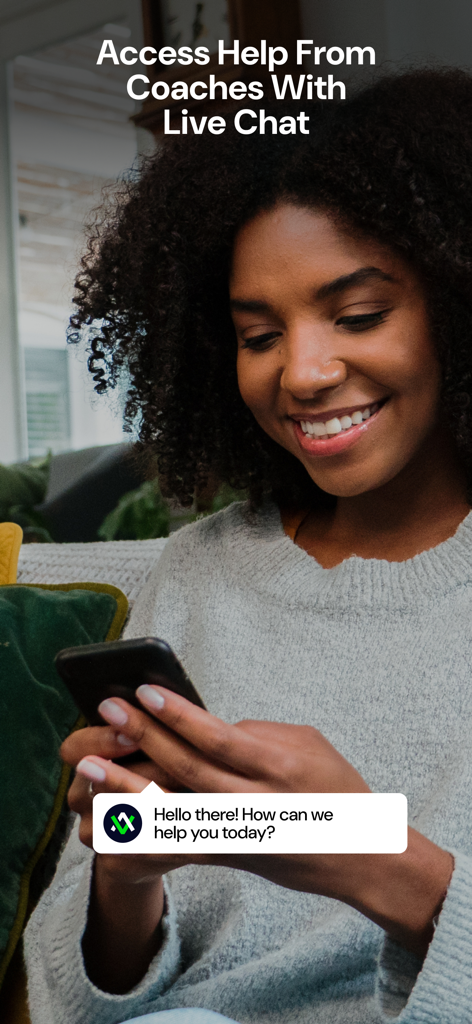 A woman smiling while using the Avatar Nutrition app to access live chat support from certified coaches