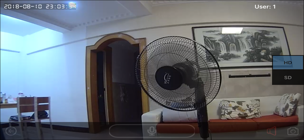 Live video feed from a ULar security camera showing a living room interior with a fan and sofa.