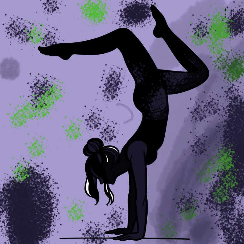 a woman doing a handstand