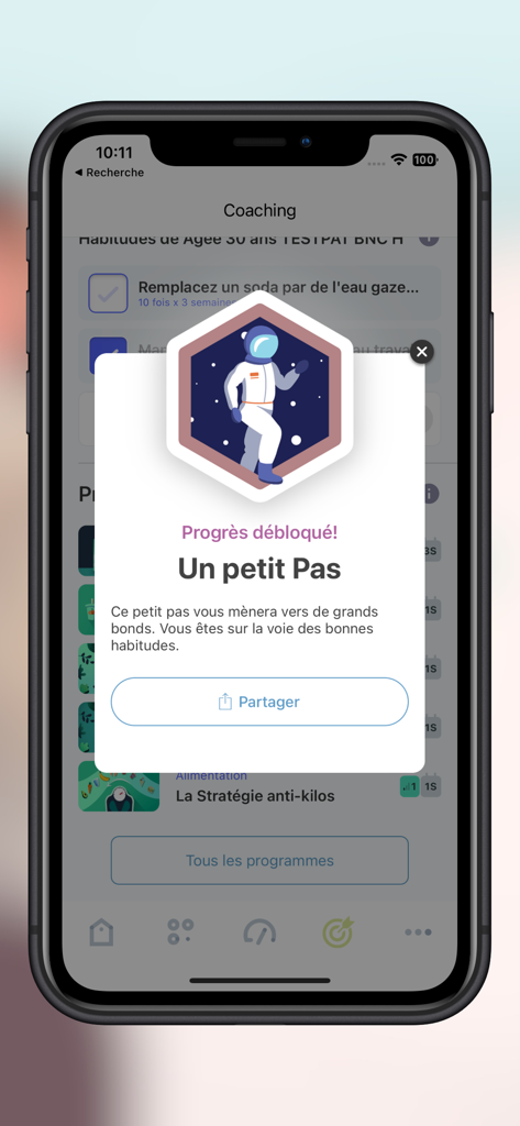 B-neXt CARE mobile app achievement pop-up showing progress unlocked with an astronaut illustration
