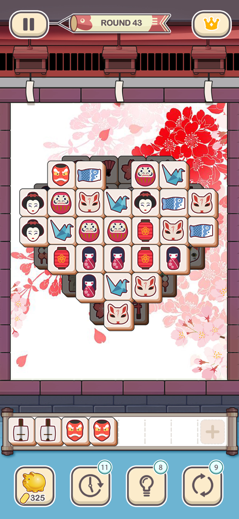 Juego móvil Tile Fun mostrando un puzzle en forma de corazón con losetas temáticas japonesas y un fondo de flor de cerezo