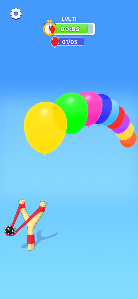 A mini game screen featuring a slingshot aiming at a row of colorful balloons