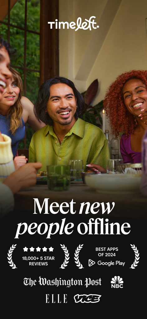 A diverse group of smiling young professionals enjoying a social dinner together at a restaurant