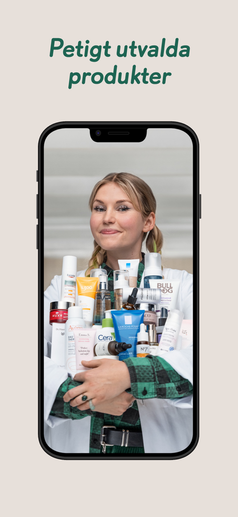 Apoteket - A woman in a white coat holding a large assortment of skincare and health products from the Apoteket app.