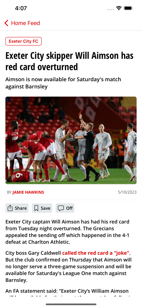 Devon Live - Devon Live news article about Exeter City FC captain Will Aimson having a red card overturned with a photo of a referee on a football pitch.