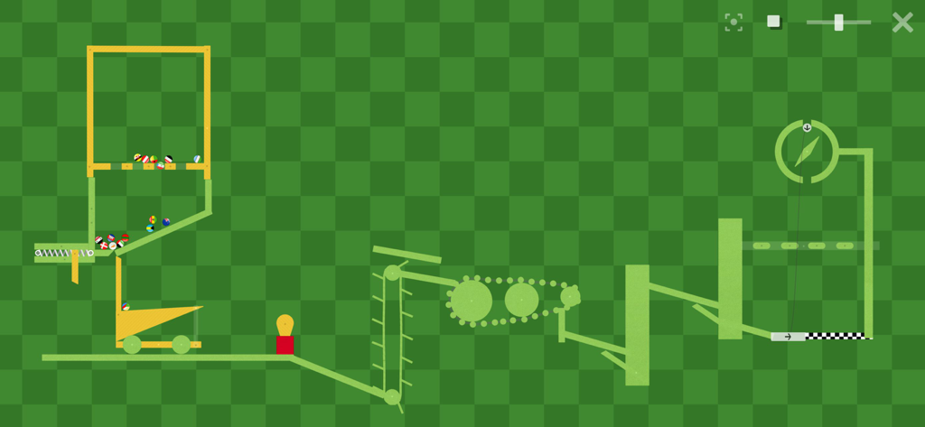 Una compleja construcción de pista de canicas con engranajes y elevadores mecánicos sobre un fondo de cuadrícula verde en una aplicación STEM basada en física.