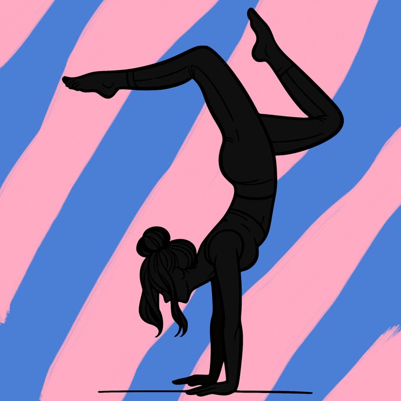 a woman doing a handstand