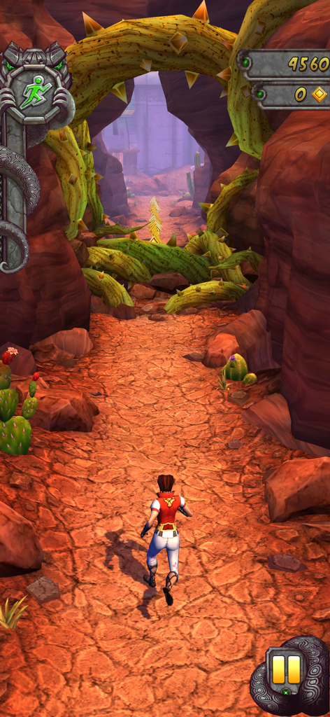 A character running through a desert canyon level in Temple Run 2 with spiked vines and cacti.