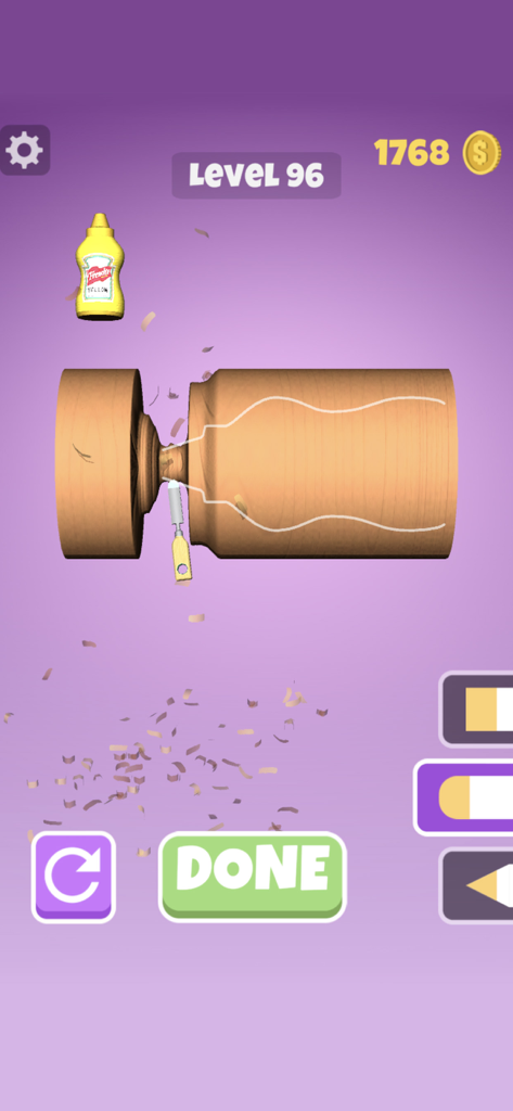 Wood Shop - Jugabilidad de la aplicación Wood Shop que muestra un bloque de madera siendo tallado en la forma de una botella de mostaza.