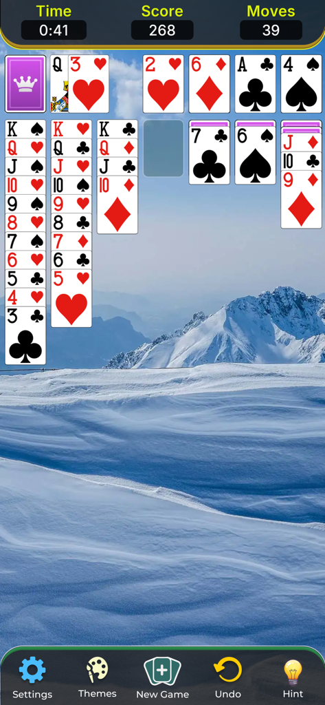 Solitaire Classic Game. - Classic Klondike solitaire game screen with a snowy mountain background.