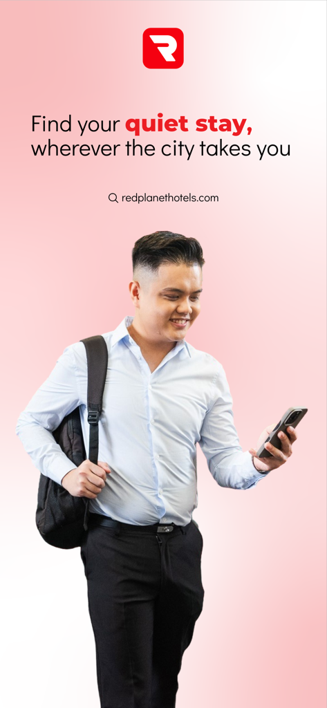 A man with a backpack using his smartphone to book a stay on the Red Planet Hotel app