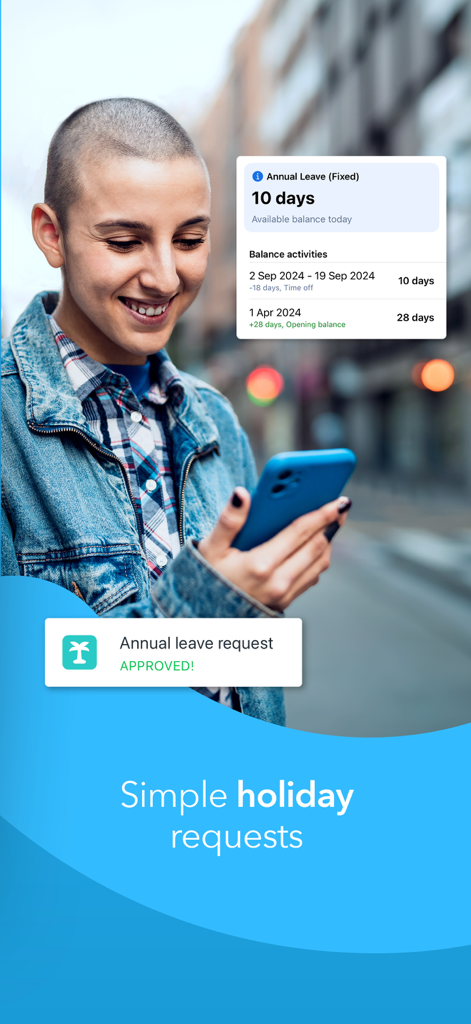 A young employee smiling while using the Planday mobile app to manage annual leave and holiday requests