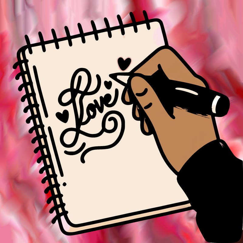 a hand writing “love” in calligraphy on a notebook