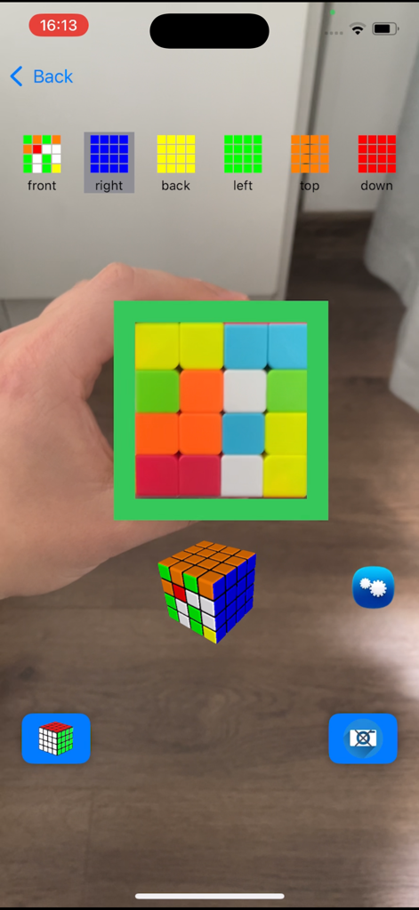 Magic Cube Solver 5x 3x 4x 2x - A hand holding a 4x4 magic cube while the app's camera scans its colors for detection.