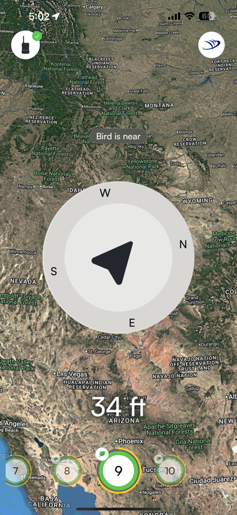 AeroVision7 app screenshot showing a satellite map of the Western USA with a large compass overlay and text indicating a bird is 34 feet away.