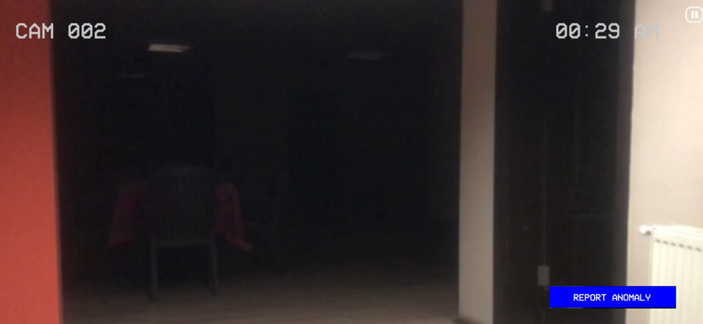 Paranormal Inc. - Dark room monitored by CCTV with a report anomaly button in the game Paranormal Inc