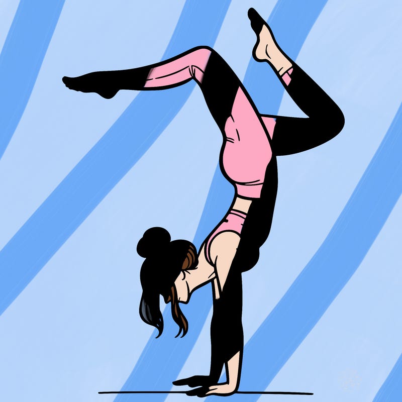 a woman doing a handstand