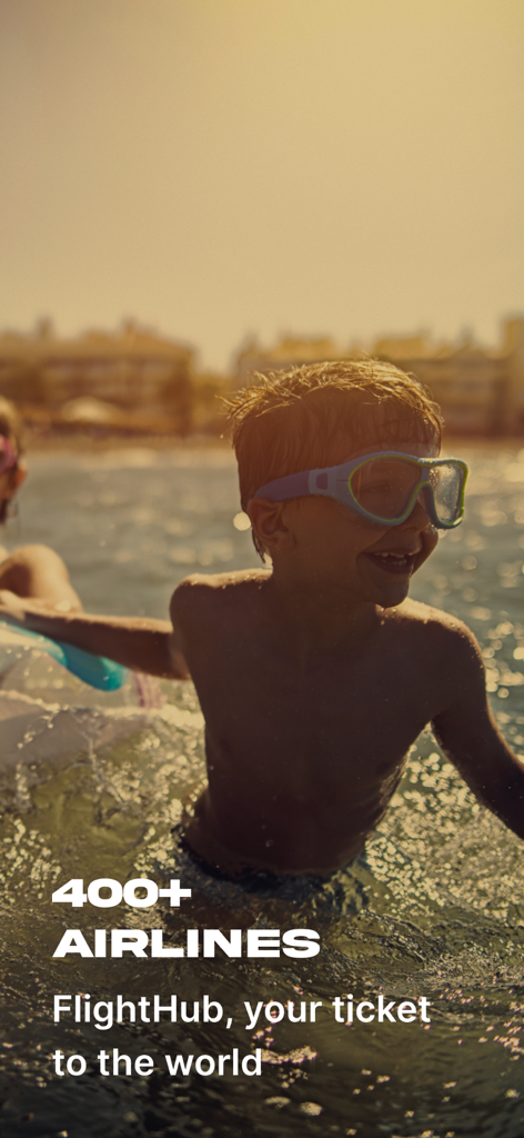 A young boy wearing swimming goggles in a sunny pool with text mentioning over four hundred airlines.