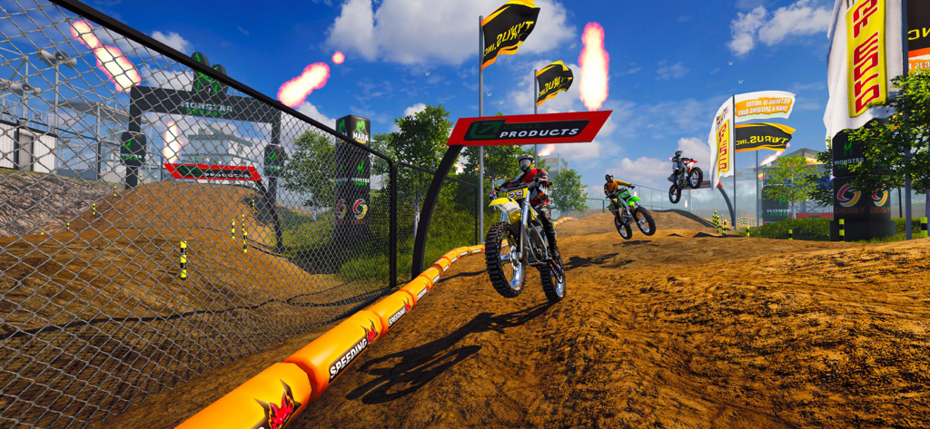 Motocross riders performing jumps on a professional dirt bike racing track with pyrotechnics